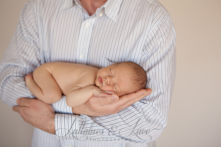 newborn boy in dads arms